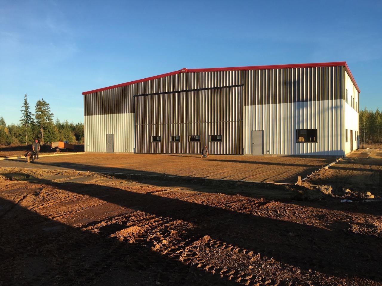 New hangar building with red roof, commercial construction